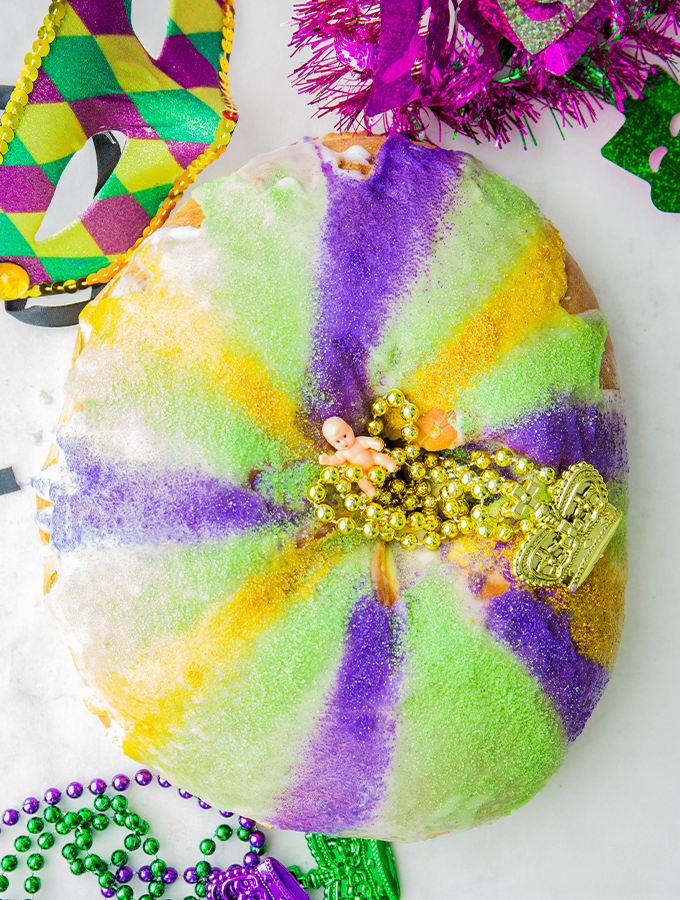 overhead shot of a king cake with plastic baby in the center