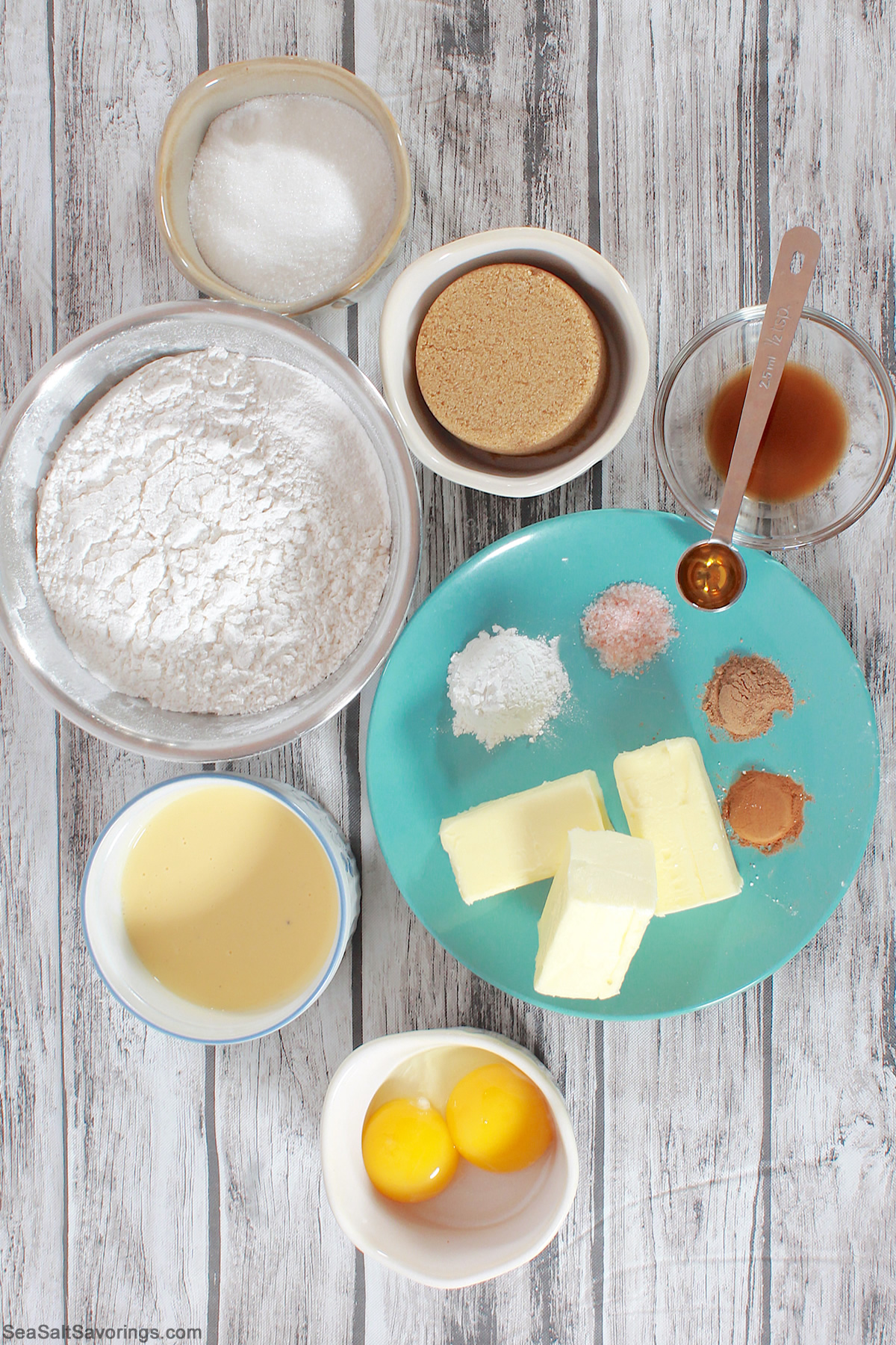 ingredients for eggnog cookies in bowls on a table