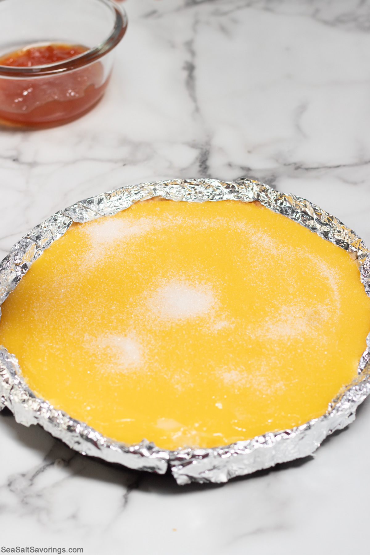 pouring sugar on top of tart pie