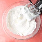 A blender is mixing the whipped topping and Greek yogurt.