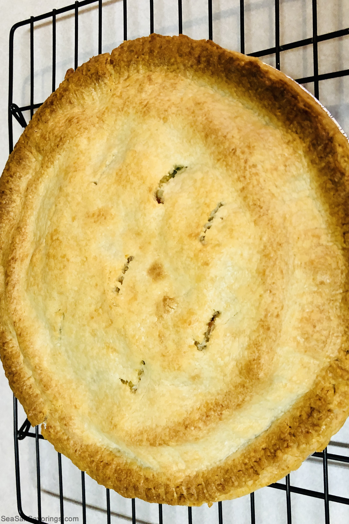 cooked chicken pot pie on a rack 