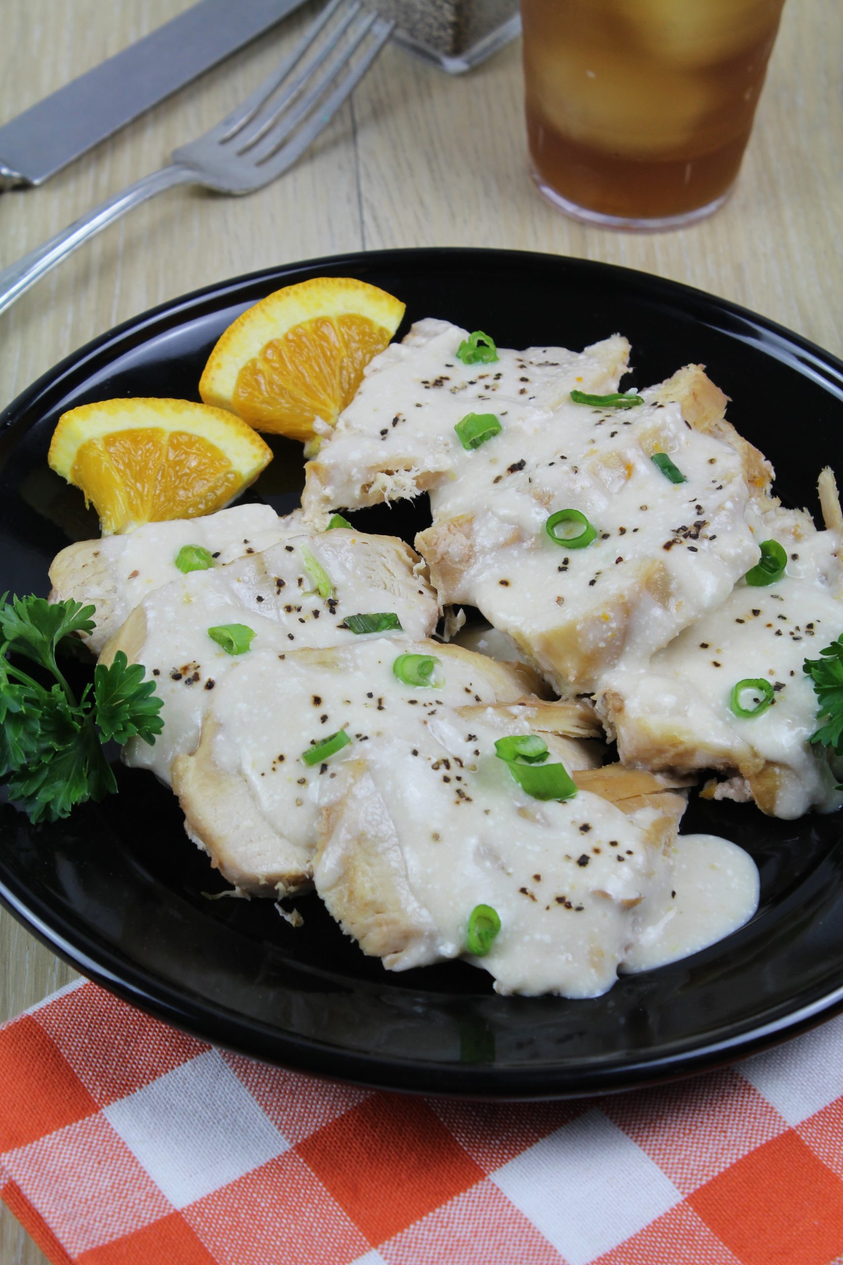 chicken with orange sauce on top on a plate