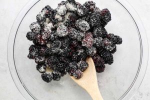 Blackberries are tossed with sugar and lemon juice.