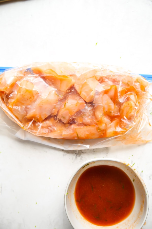 The chicken chunks are marinated in the sriracha sauce in a Zip Lock bag.