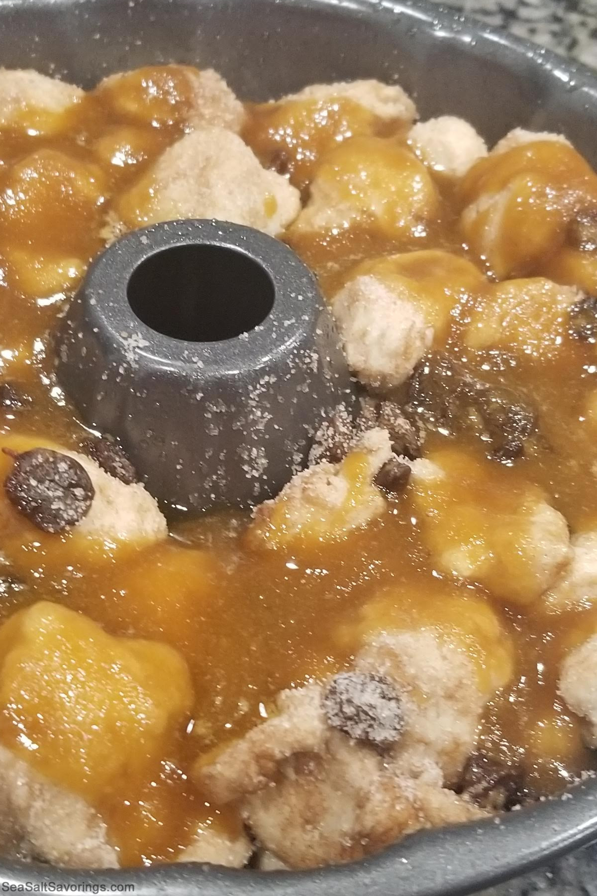 bread chunks mixed with syrup base inside a bundt baking dish