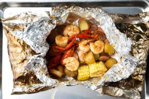 The shrimp foil packet is cooked and unwrapped and ready to eat.