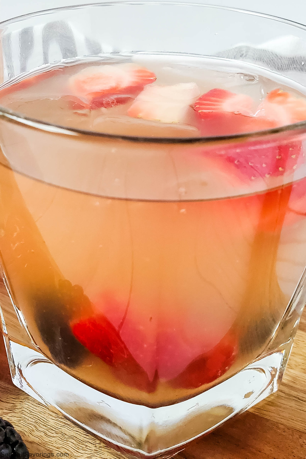 close up view of side of glass of berry sangria