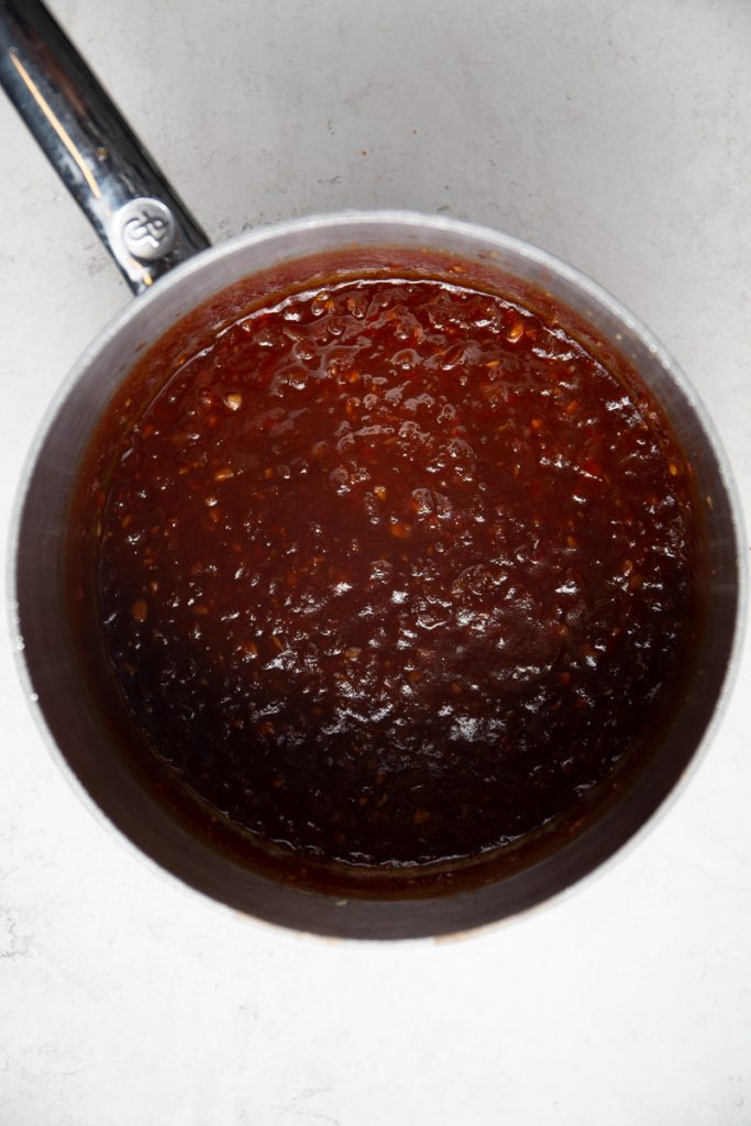 Homemade BBQ sauce is made in one pan is is simmered until it is thick.