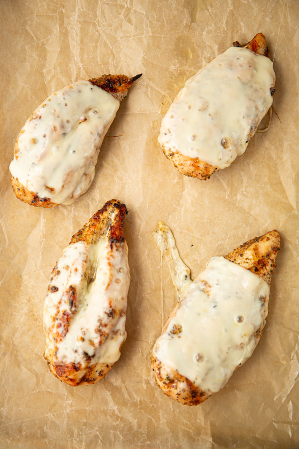 Chicken breasts are grilled and topped with melty mozzarella cheese.