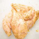 Chicken breasts are seasoned with olive oil, garlic powder, Italian seasoning, and a pinch of salt.