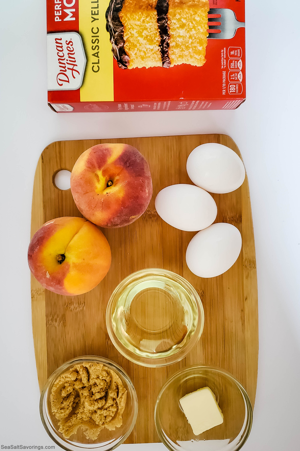 ingredients on a cutting board including a box of yellow cake mix