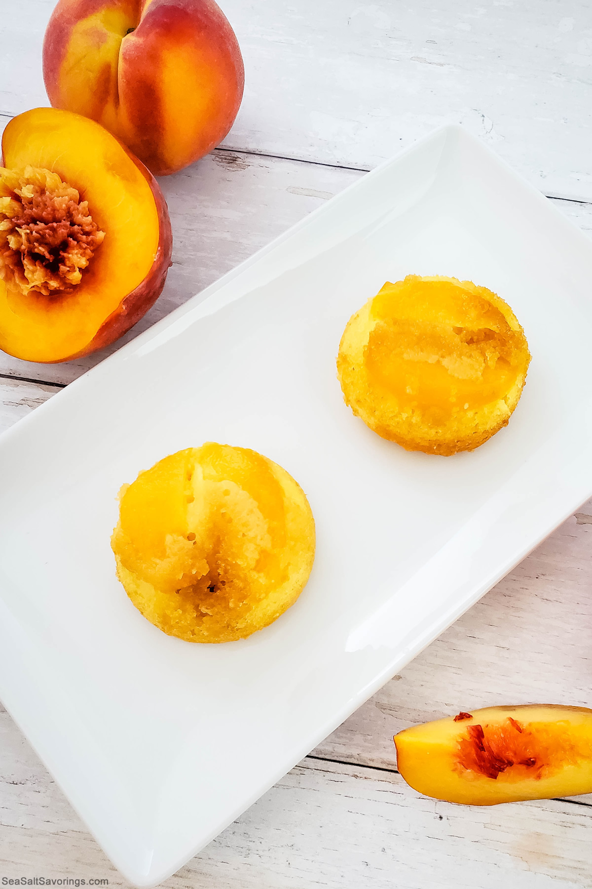 two peach cupcakes on a white plate