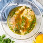 Chicken breasts are placed in a bowl with mojo marinade for a minimum of 30 minutes.