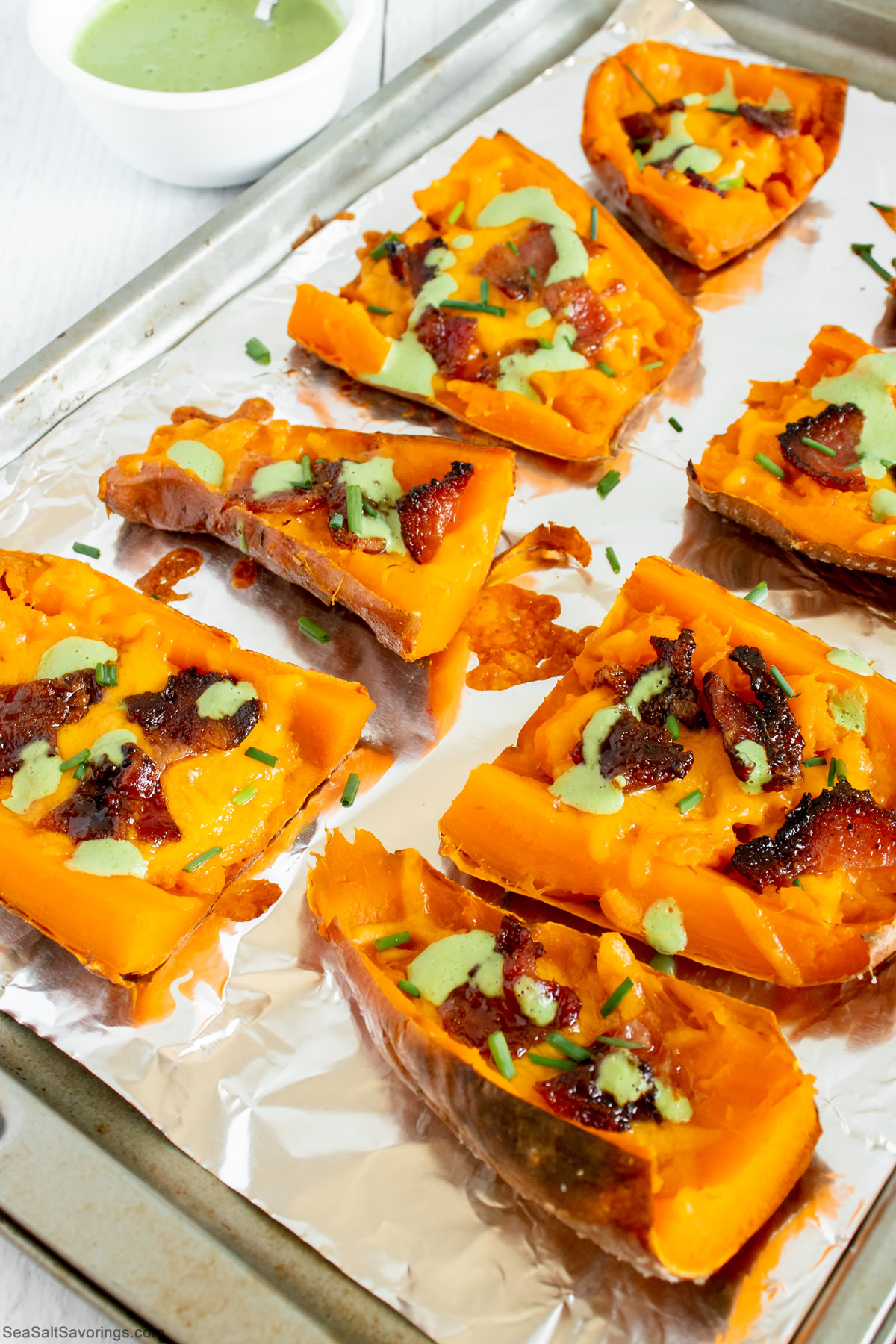 baking sheet full of loaded sweet potato skins