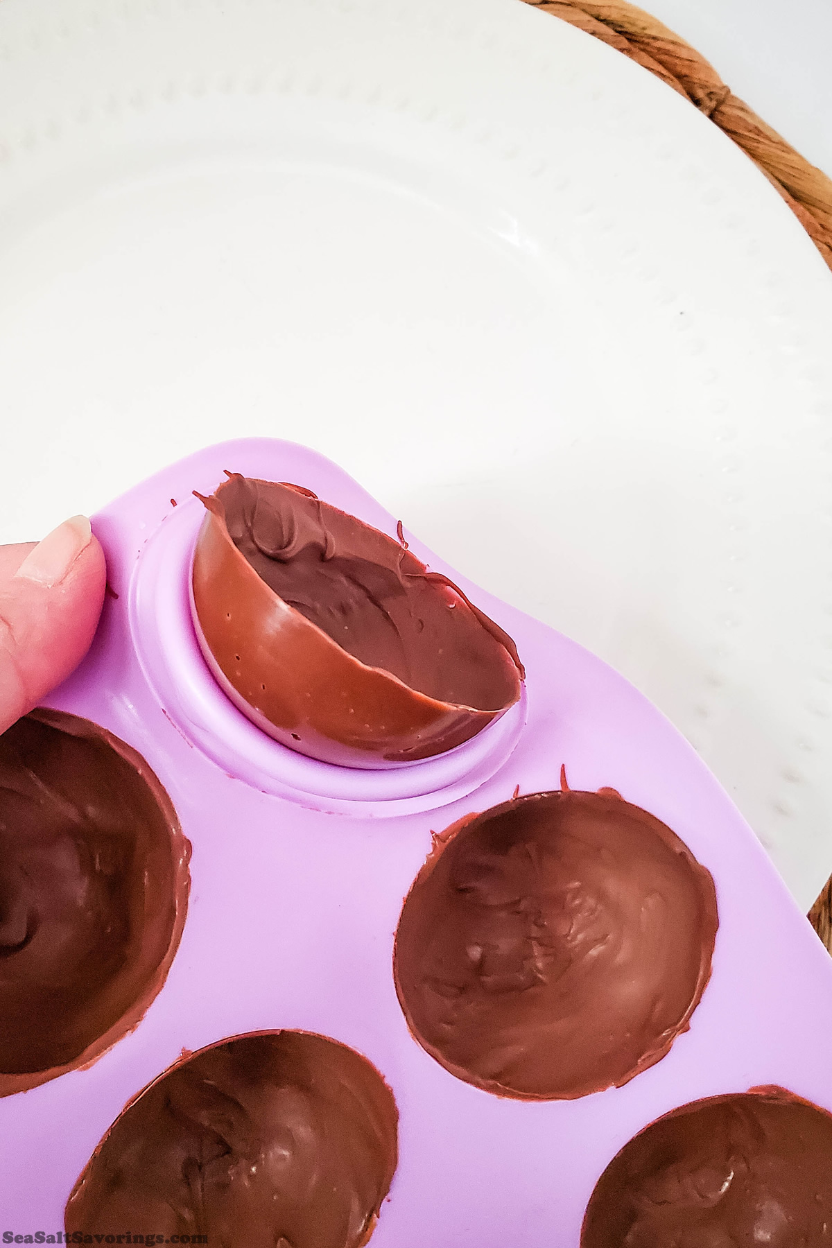 peeling a half chocolate ball out of mold