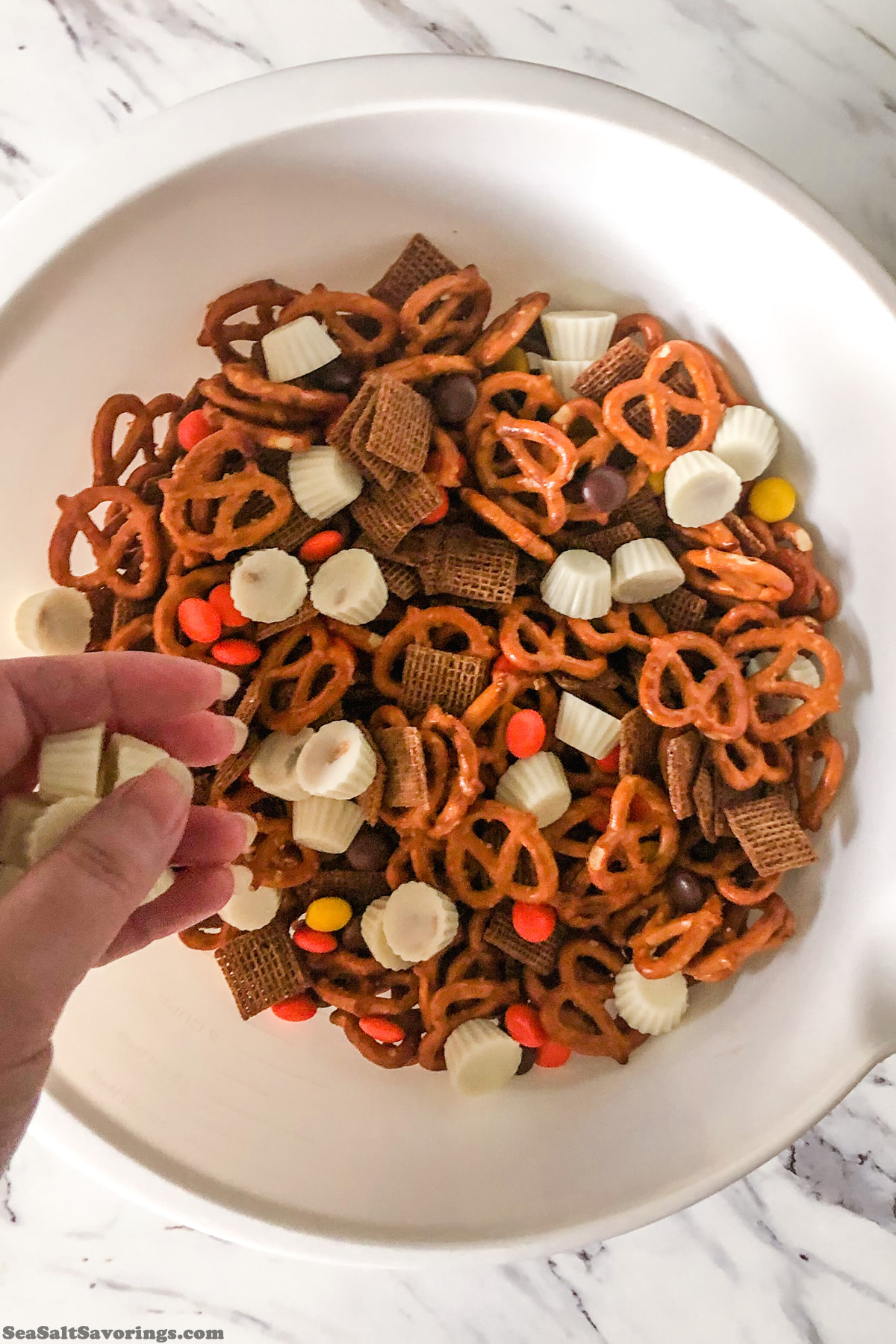 adding candies to mixing bowl