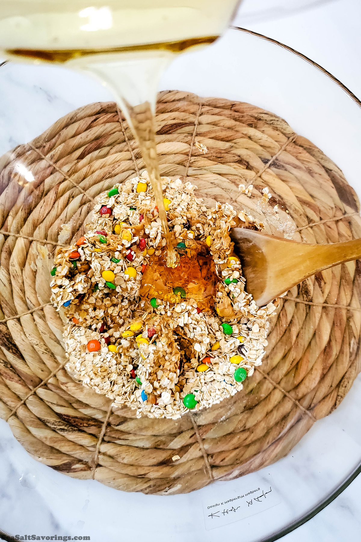 adding wet ingredients to dry ingredients in mixing bowl