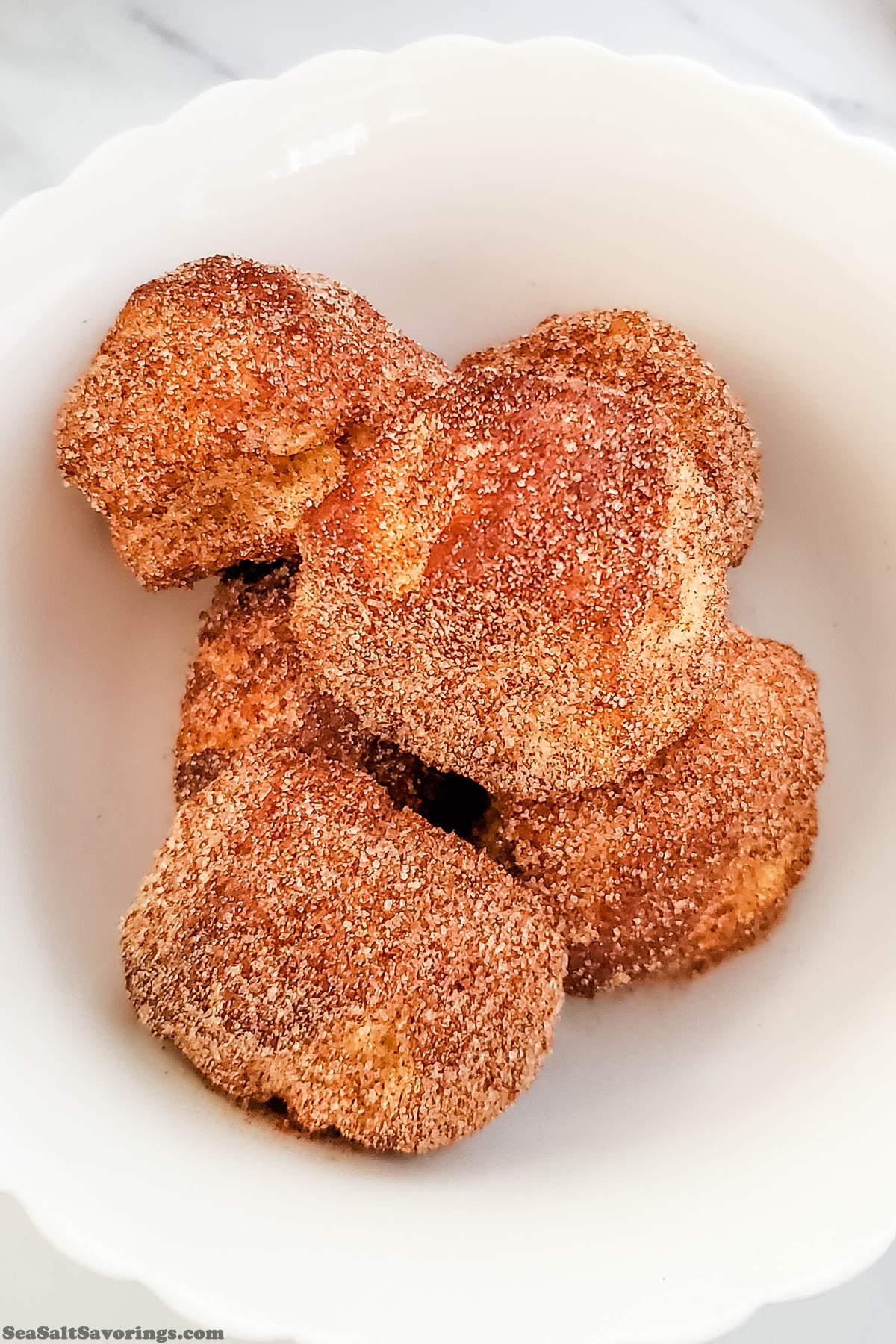 close up view of pumpkin spice donuts in a bowl