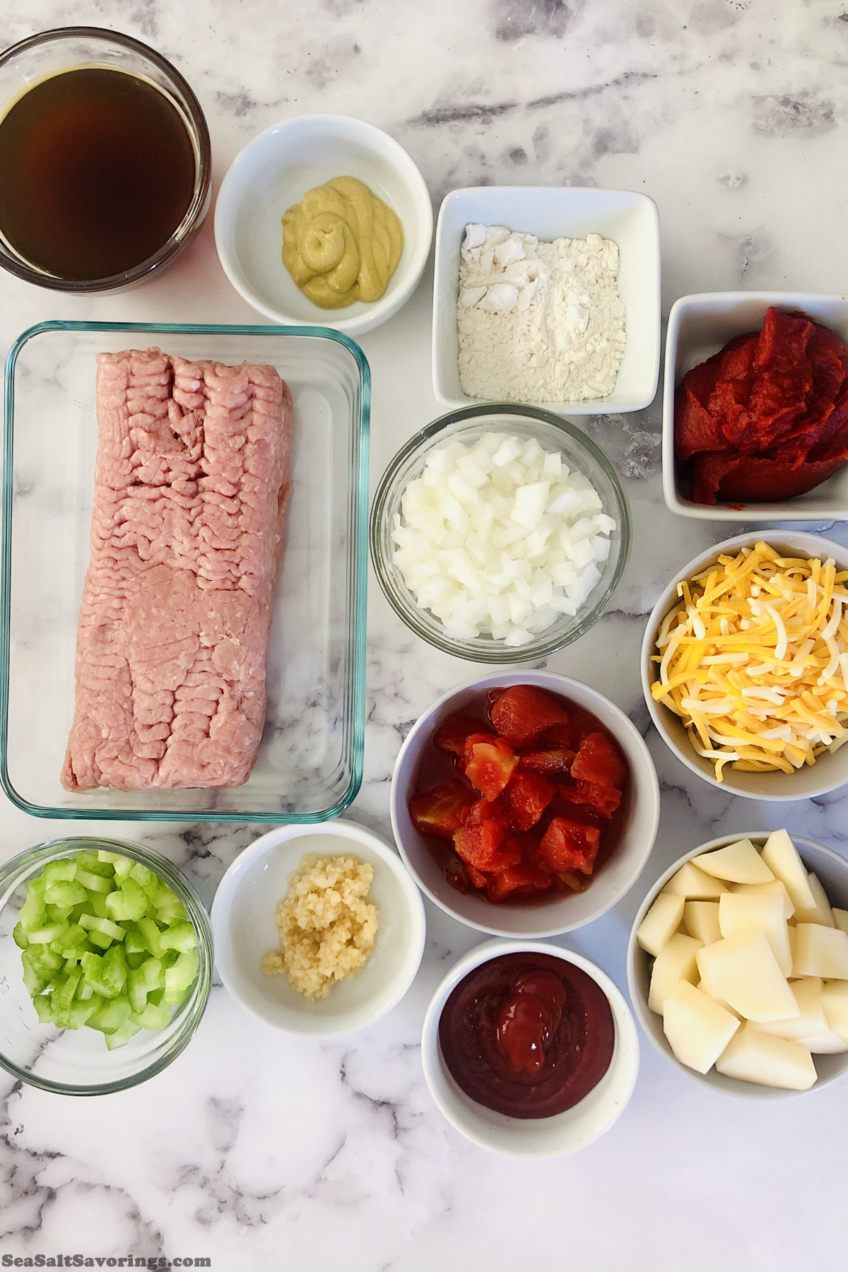 raw ingredients in bowls and dishes on a table for cheeseburger soup