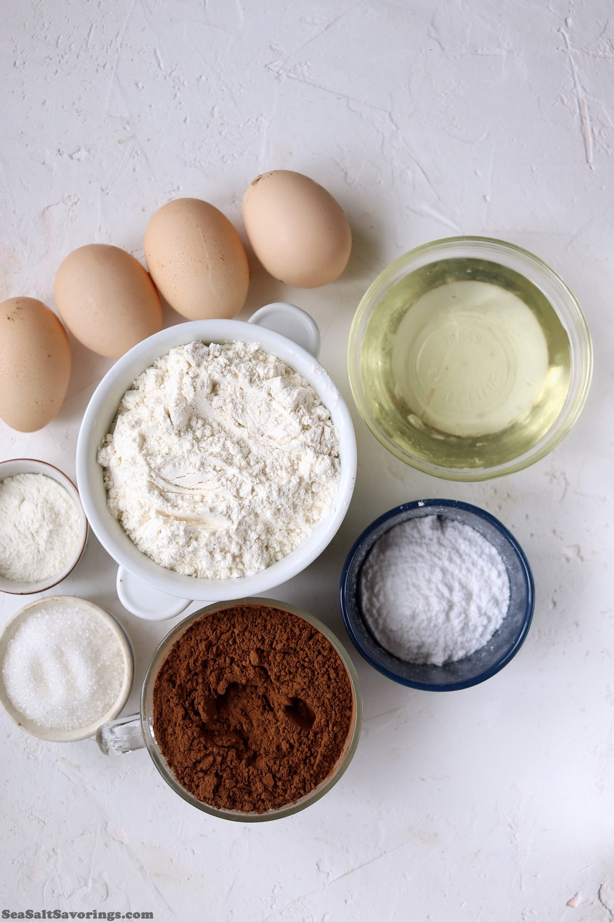 ingredients laid on table to make chocolate crinkle cookies