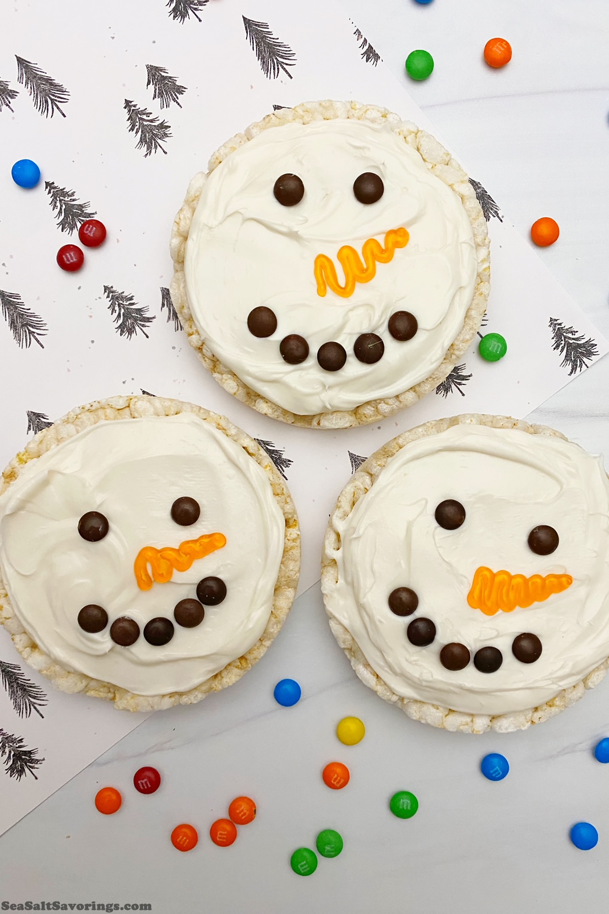 close up of three decorated rice cakes in the style of a snowman heads