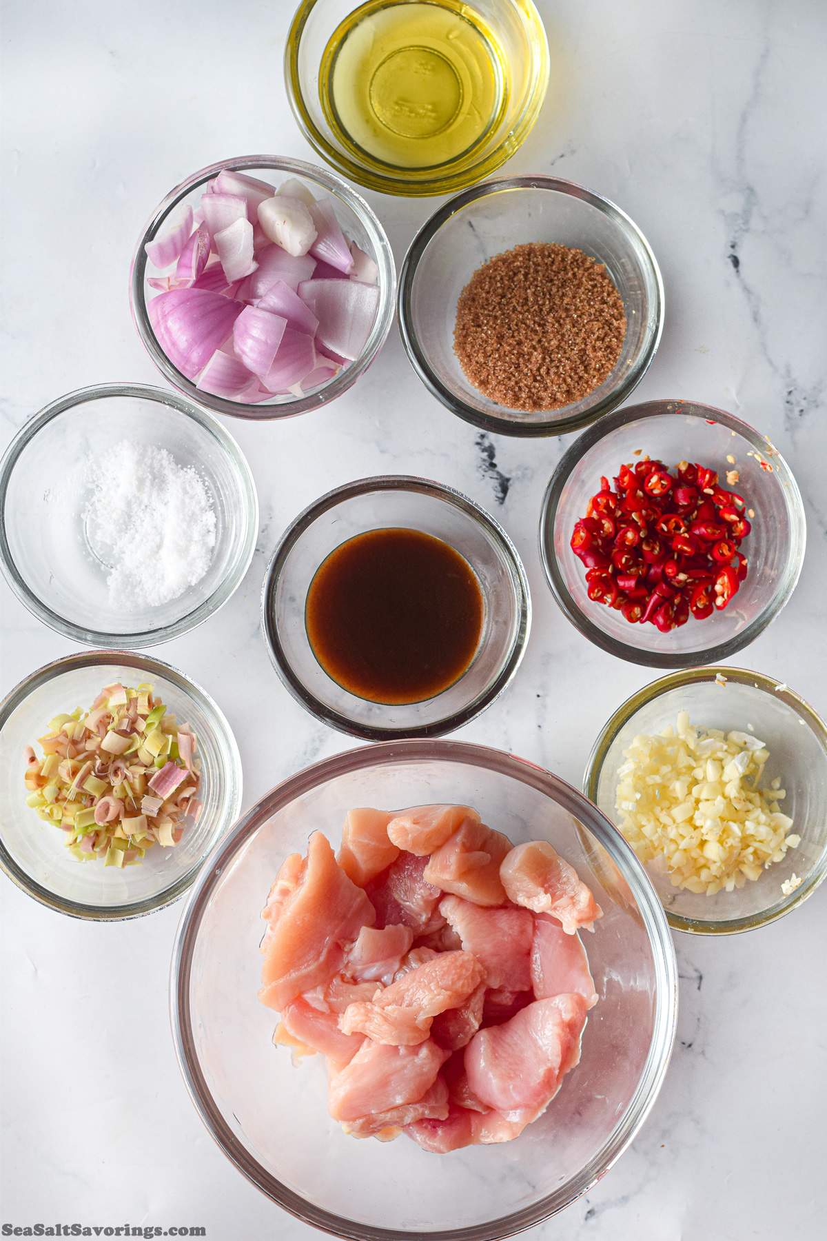 ingredients for chicken chili in bowls on a table