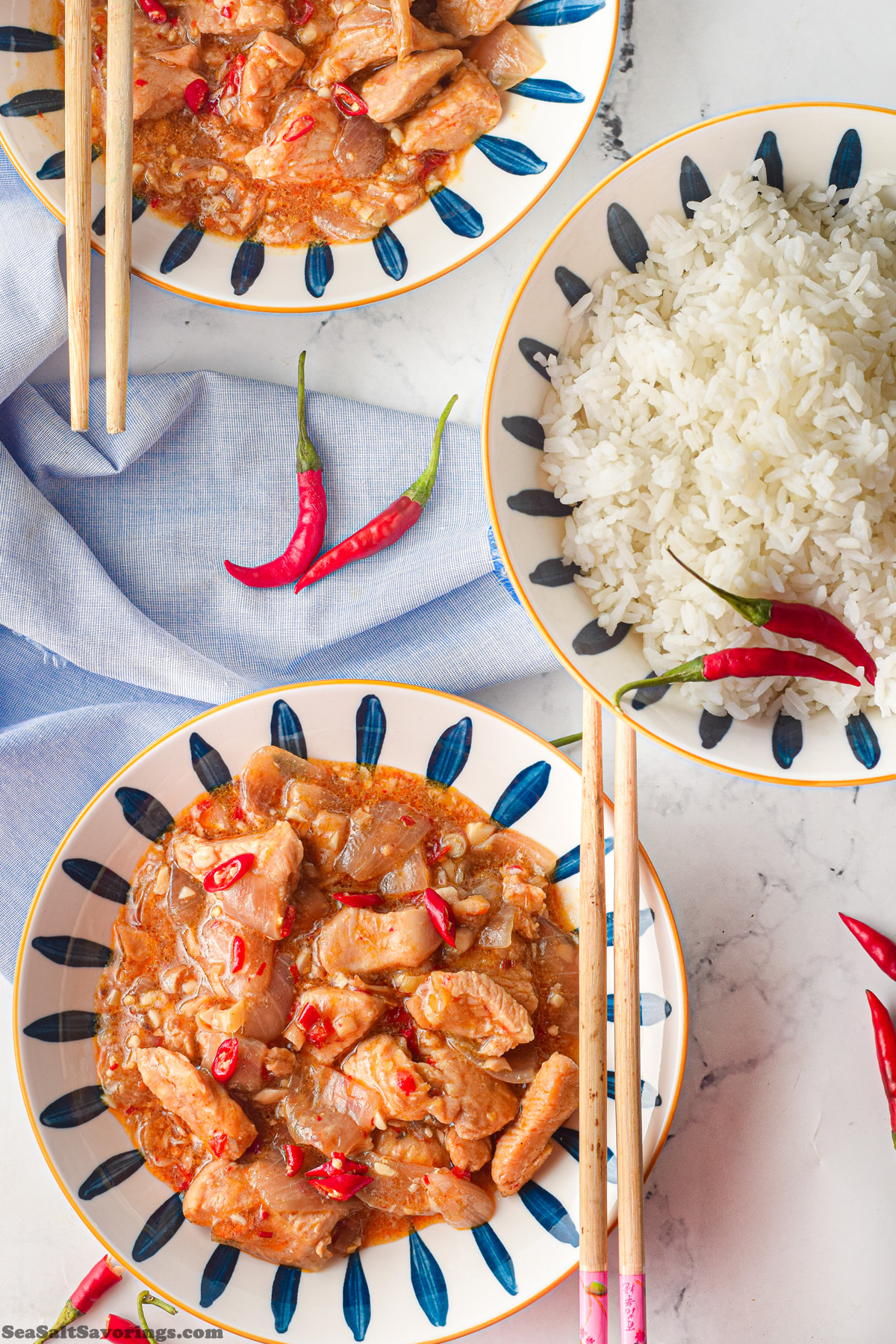 bowl of chicken chili next to a bowl of white rice