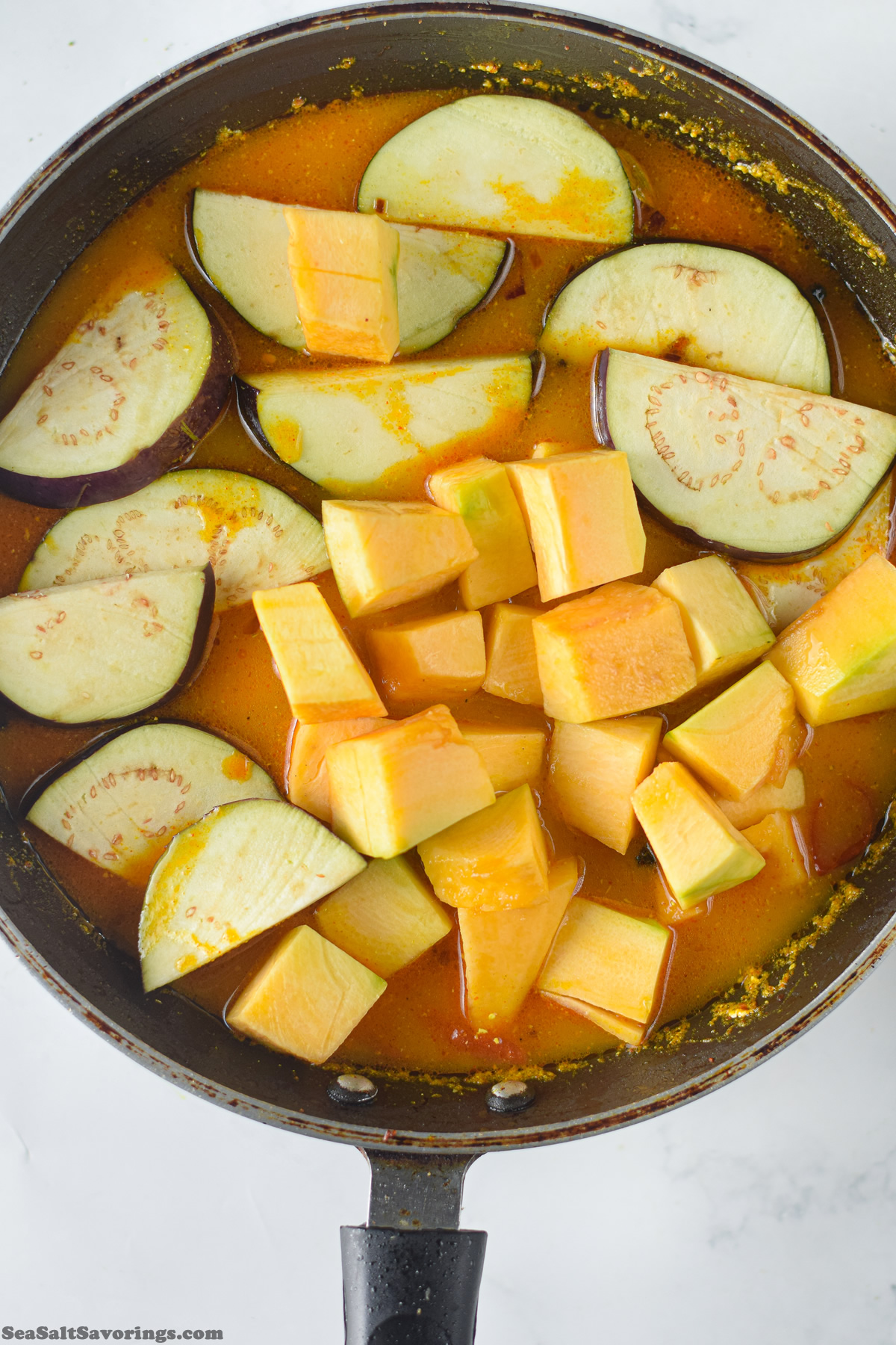 view of the pan with fresh vegetables placed into the base sauce