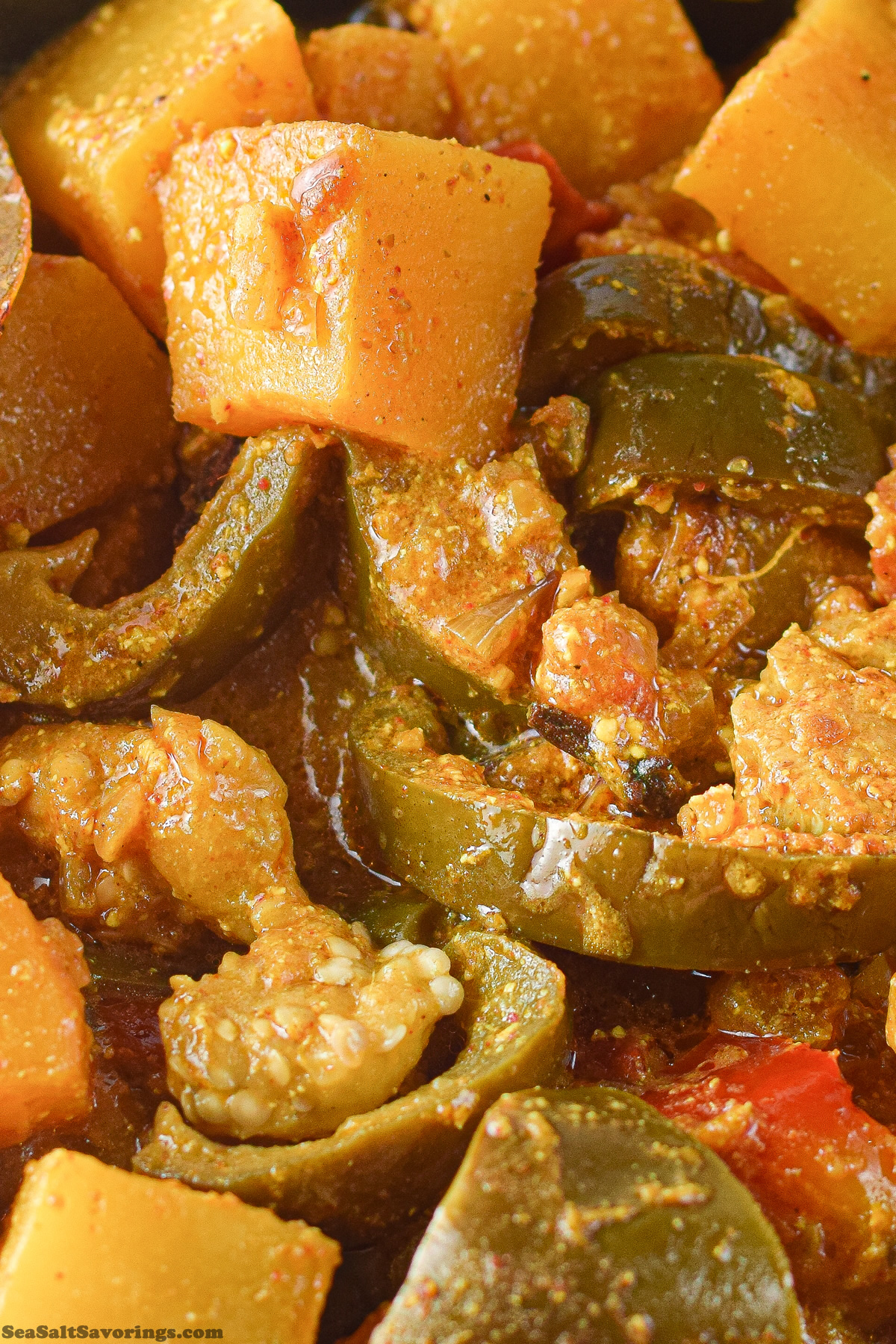 close up view of this pumpkin eggplant rogan josh dish, detailing the ingredients and rich texture of the sauce