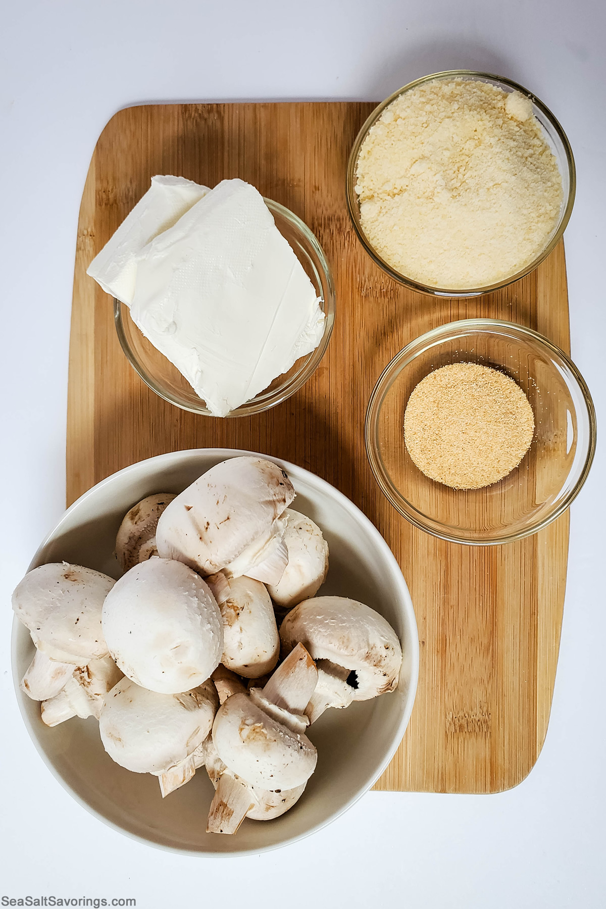 ingredients for stuffed mushrooms on a cutting board