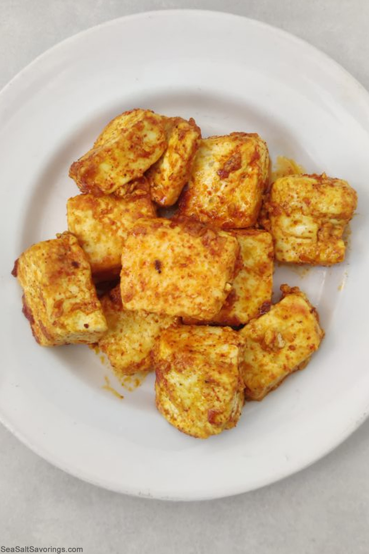 paneer cubes on a plate seasoned and fried