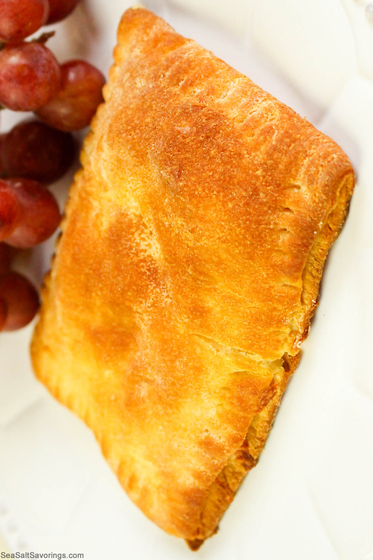 close up view of a freshly baked ham and cheese pocket sandwich detailing the crispy crust