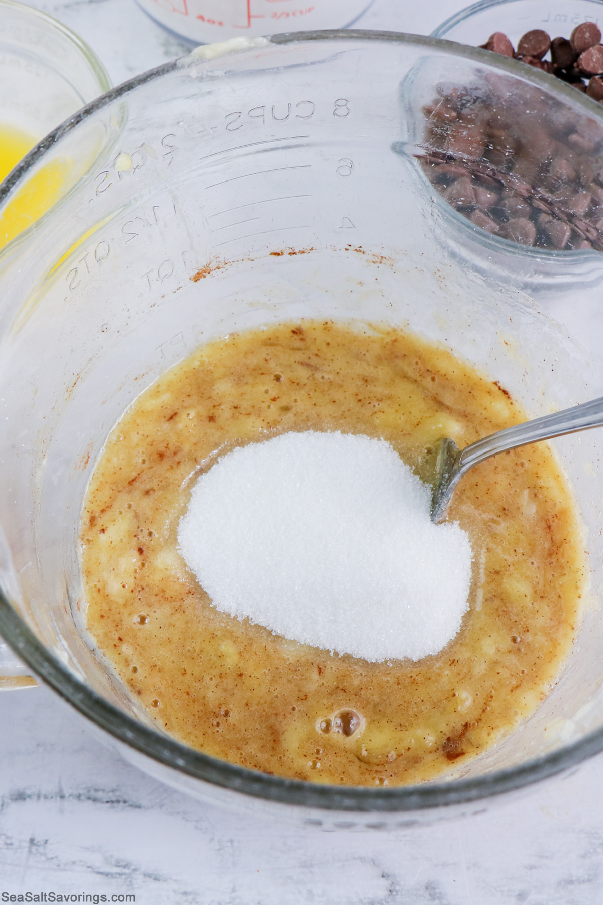 mixing wet ingredients and banana in a bowl