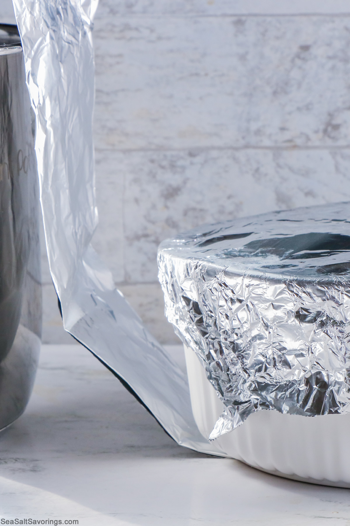 aluminum foil used to make a sling for lifting the bread pudding baking dish that is also covered in foil