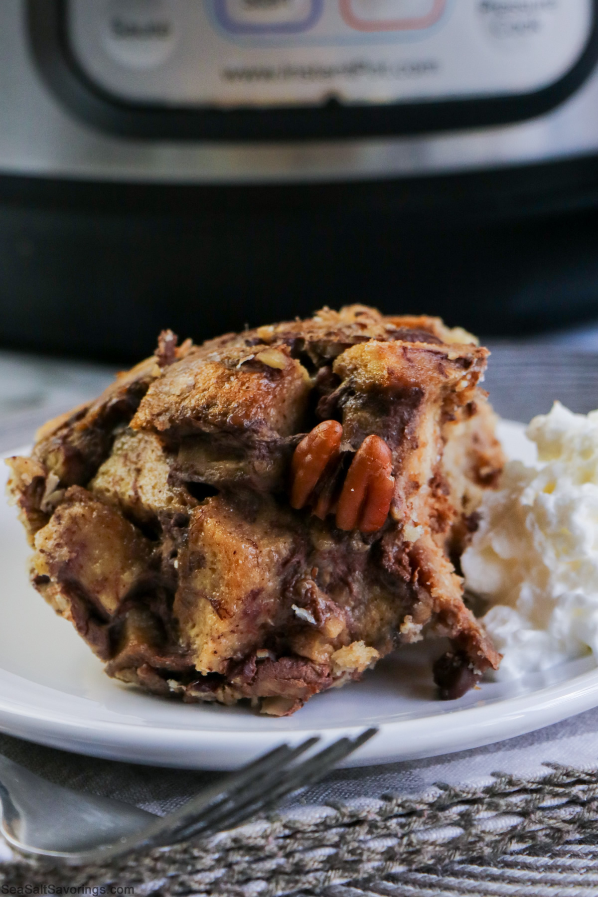 bread pudding on a plate next to a scoop of icecream