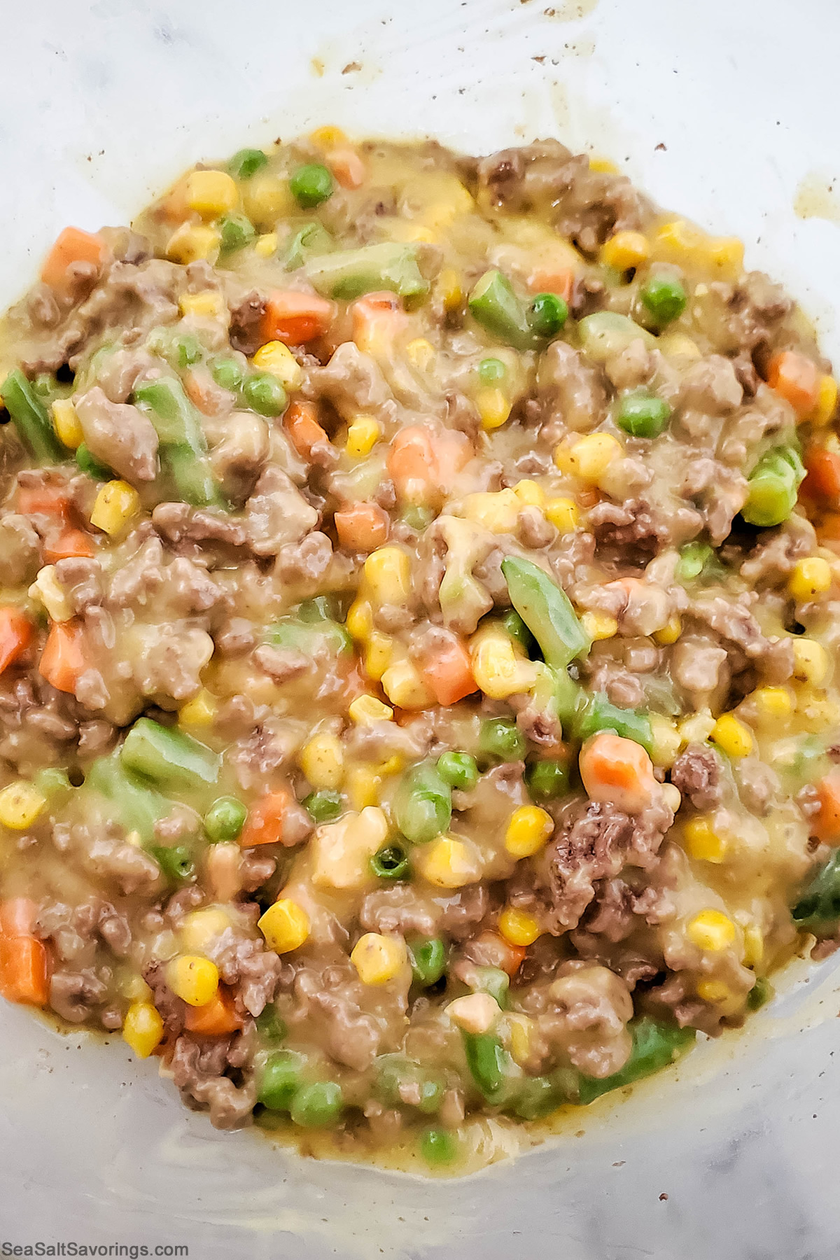 beef and soup and vegetable filling mixed up in a bowl