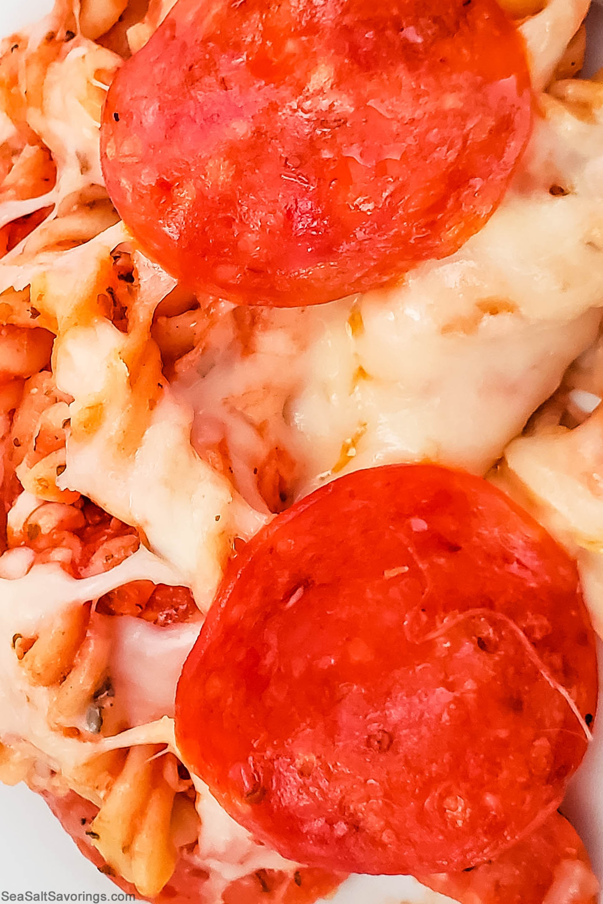 close up view of pizza casserole detailing the textures and melty cheese