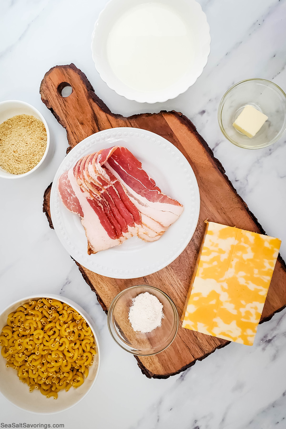 ingredients for bacon mac and cheese in bowls on a table