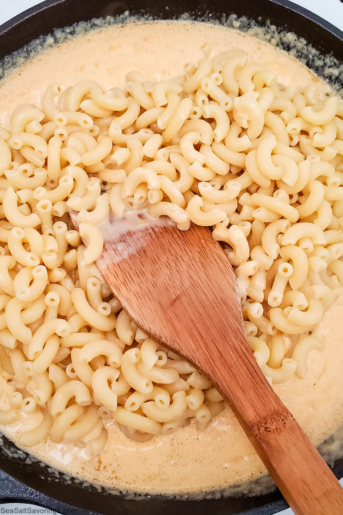 macaroni noodles added to cheese sauce