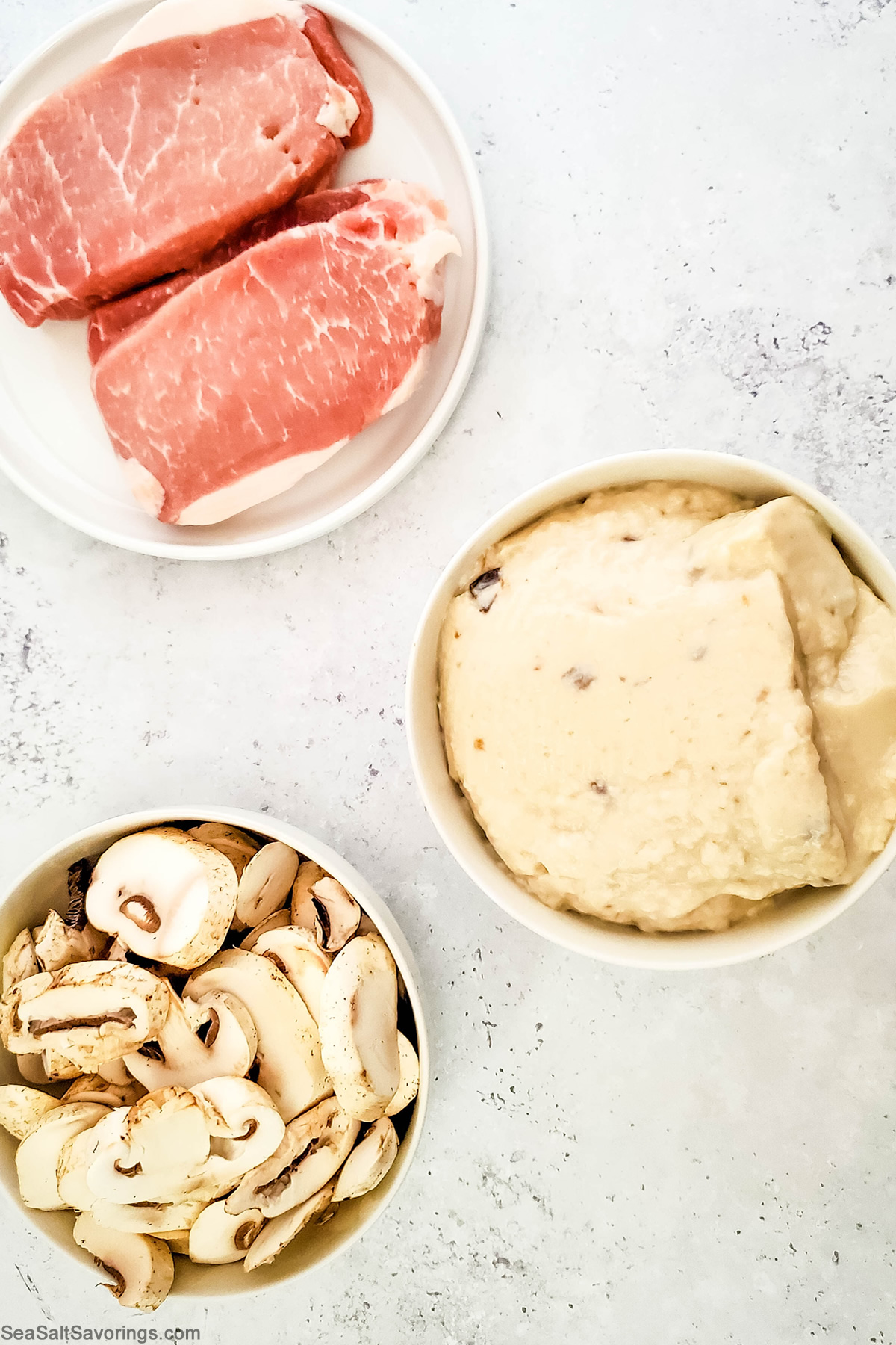 ingredients on table featuring pork chops and mushrooms and mushroom soup