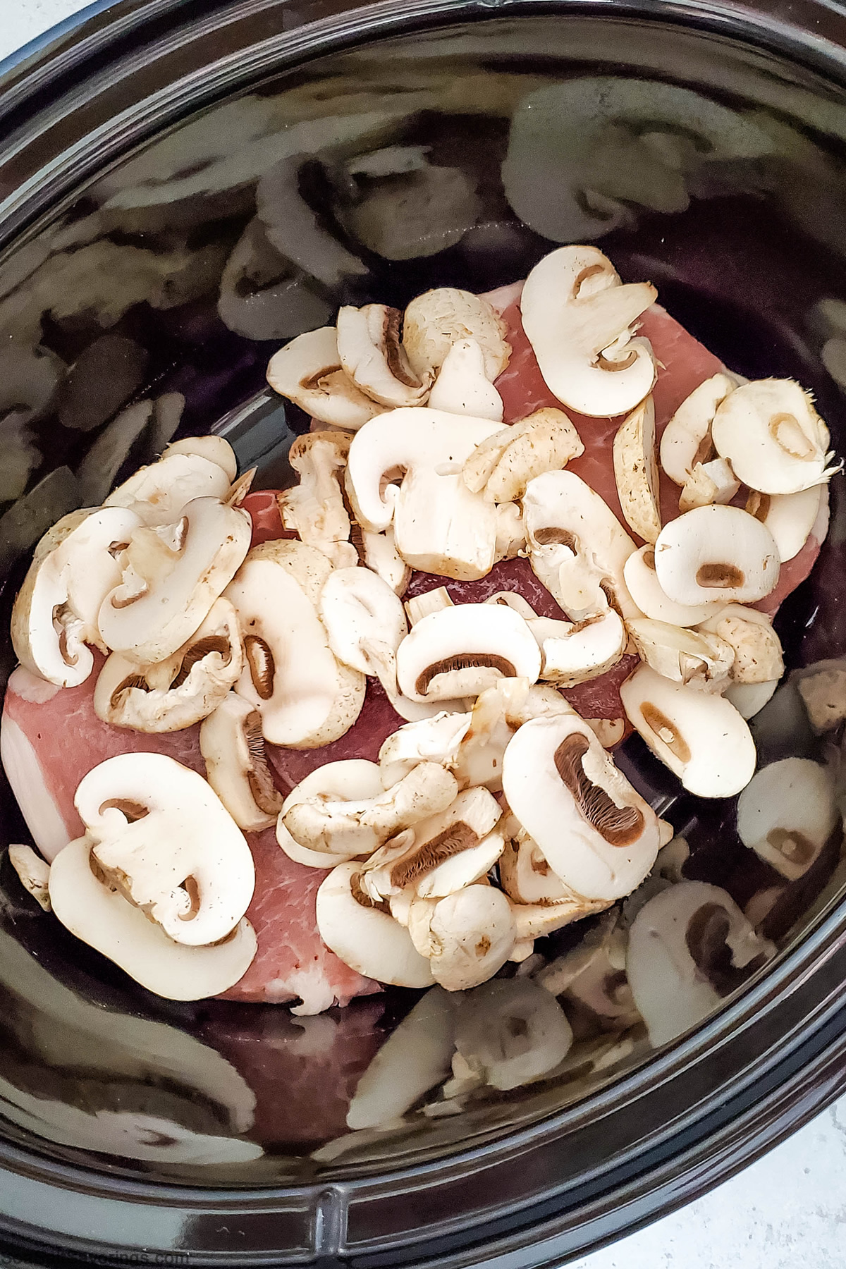 crockpot full of pork chops and mushrooms