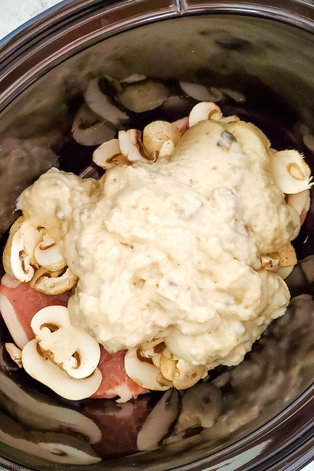 crockpot full of pork chops and mushrooms and mushroom soup