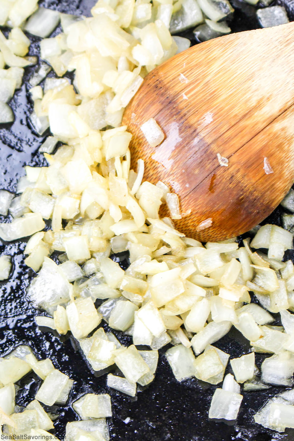 onions browning and getting stirred in a skillet