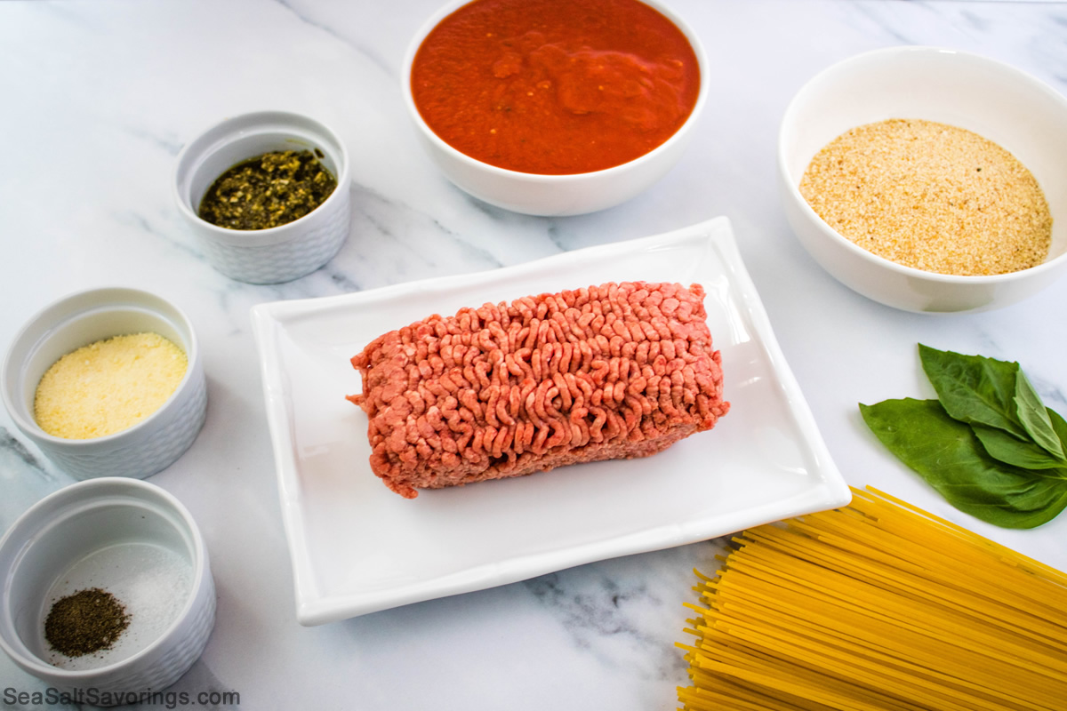 ingredients laid out on a table for pesto meatball spaghetti