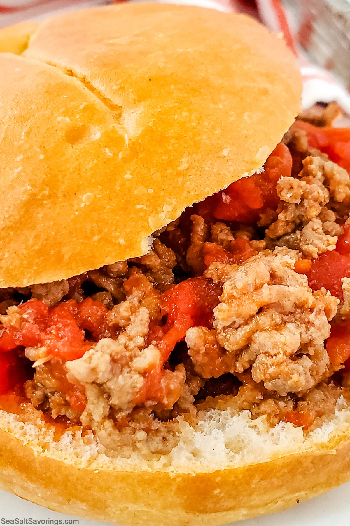 close up view of a sloppy joe sandwich with fine details of the filling