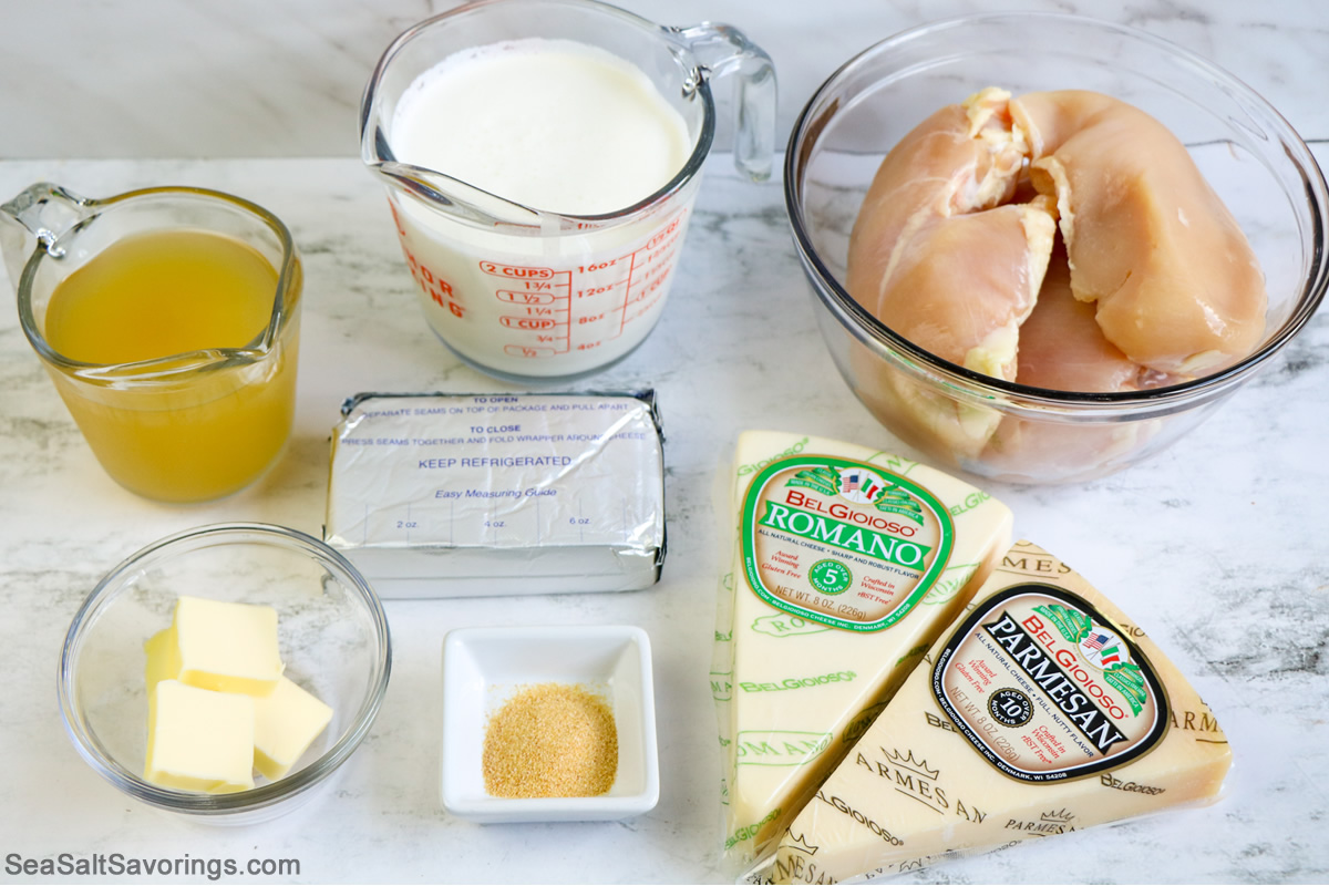 ingredients for this slow cooker alfredo dish all on a table and in bowls