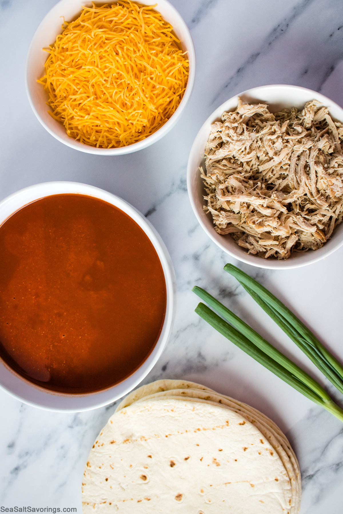 simple ingredients for pork enchiladas including sauce and tortillas and cheese