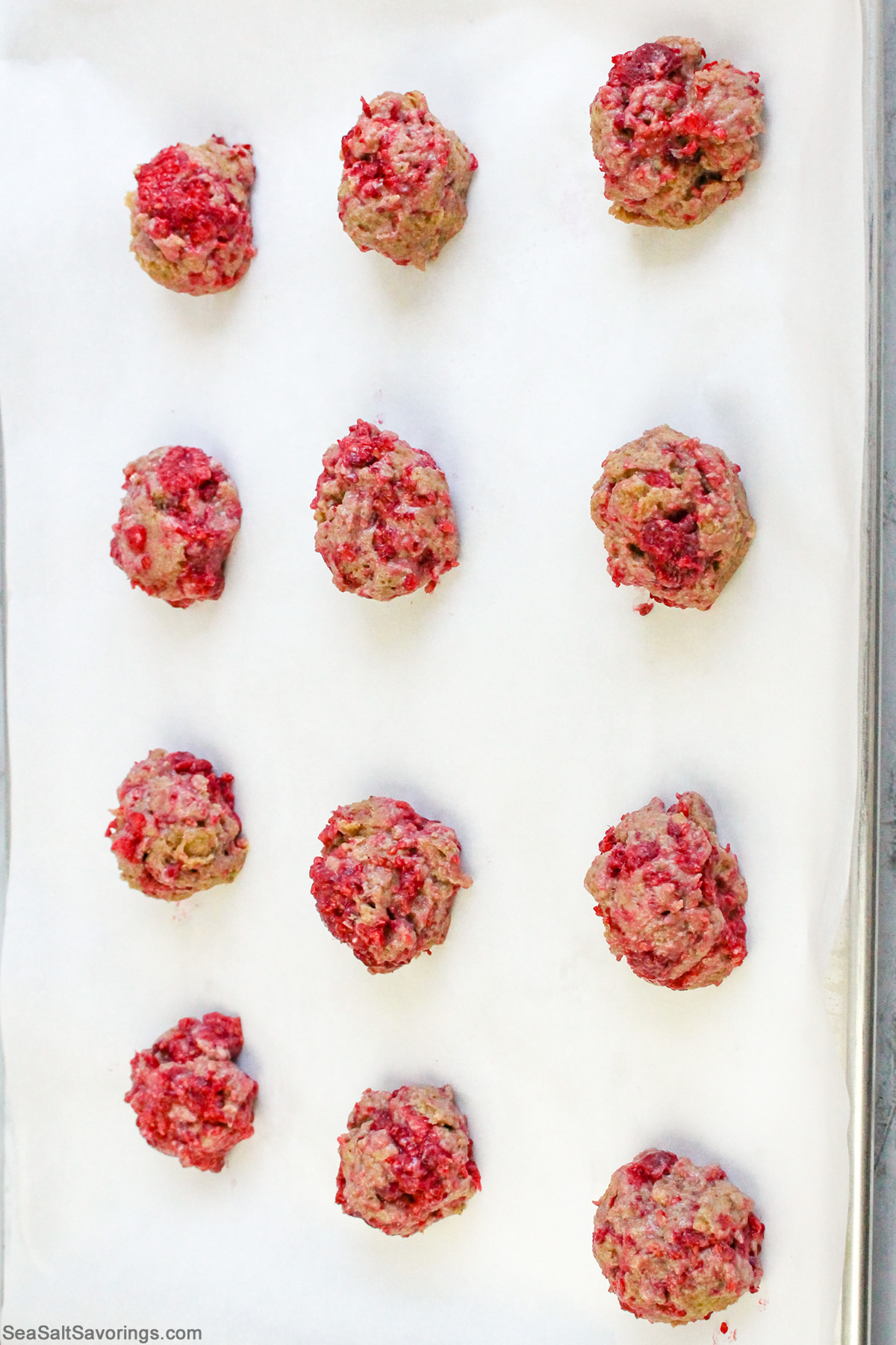 scone dough is shaped into balls and placed on a cookie sheet to bake