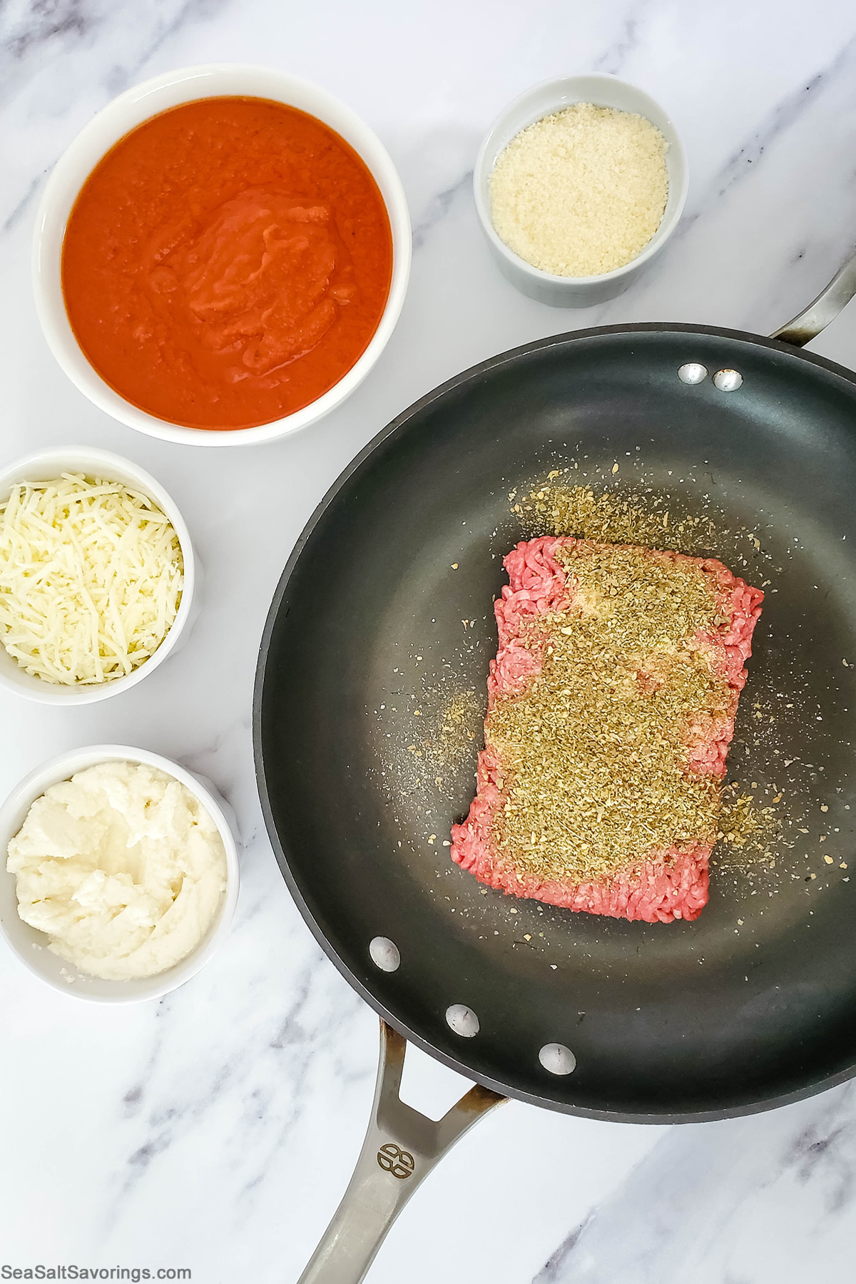 ground beef and seasoning in a skillet about to be cooked