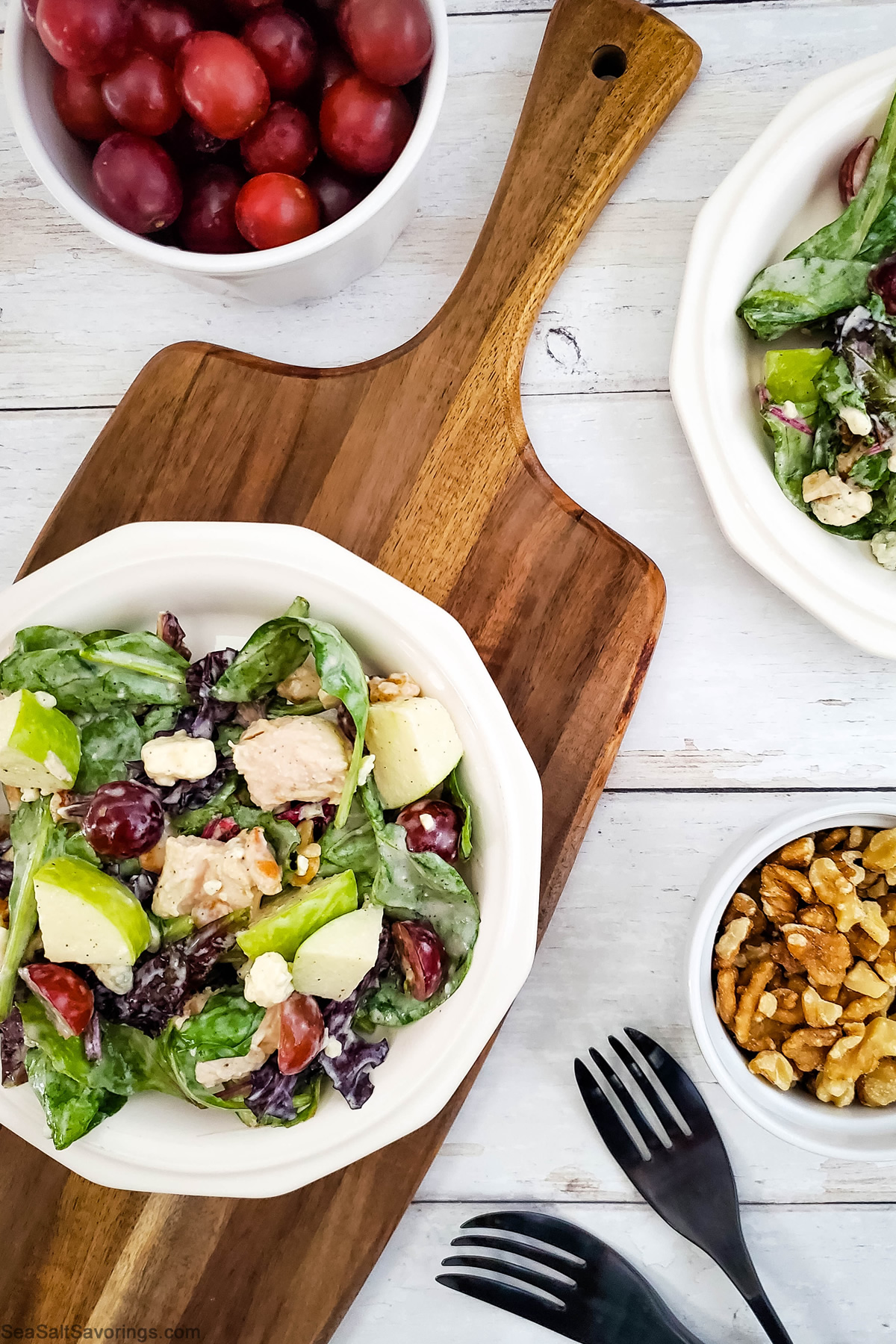 chicken apple salad in a bowl on a cutting board